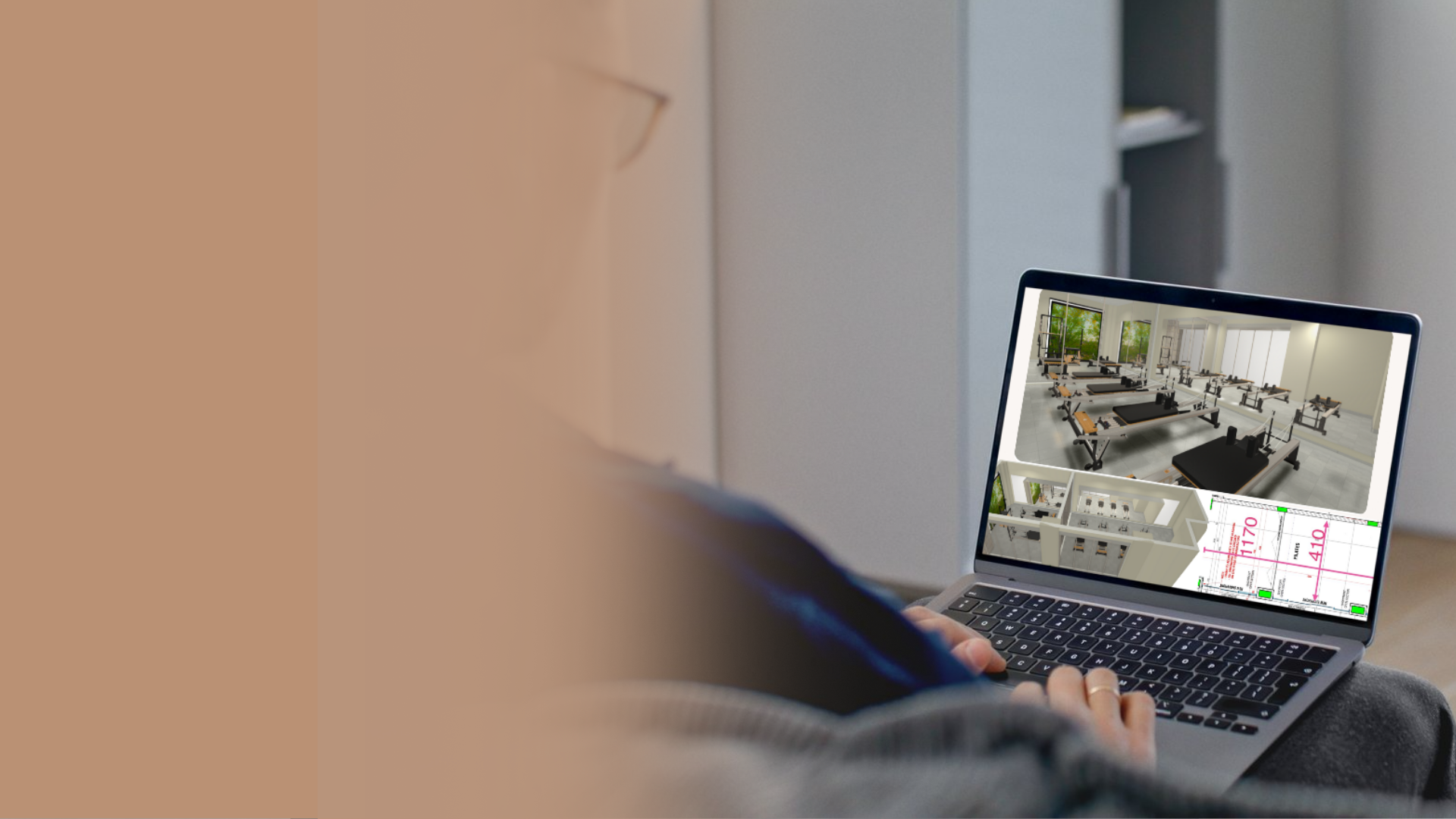 Designer reviewing a 3D Pilates studio layout on a laptop